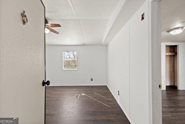 empty room featuring ceiling fan and dark hardwood / wood-style floors