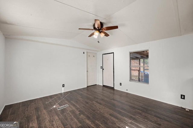 spare room with dark hardwood / wood-style flooring, ceiling fan, and lofted ceiling