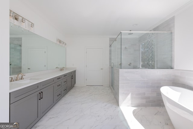 bathroom with crown molding, vanity, and shower with separate bathtub