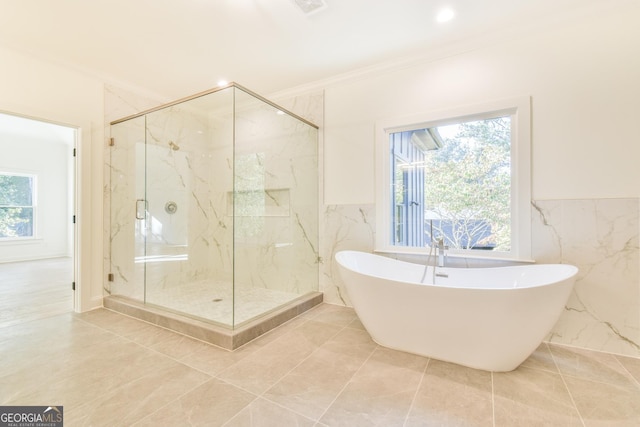 bathroom featuring crown molding, shower with separate bathtub, and a healthy amount of sunlight