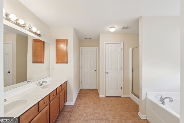 bathroom with tile patterned floors, vanity, and independent shower and bath