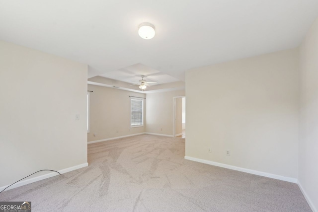 empty room with ceiling fan and light carpet