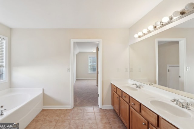 bathroom with tile patterned floors, vanity, and a bathing tub