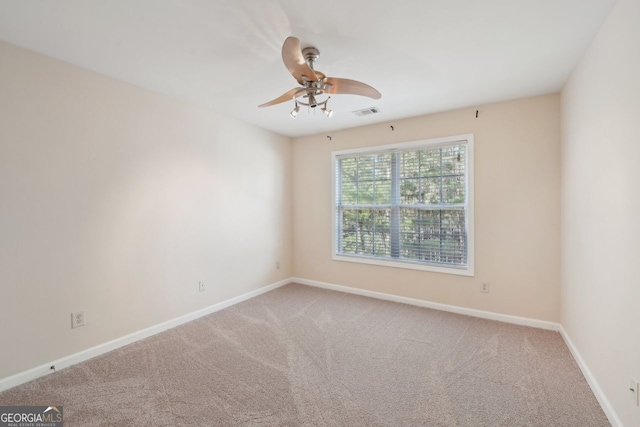 carpeted empty room featuring ceiling fan