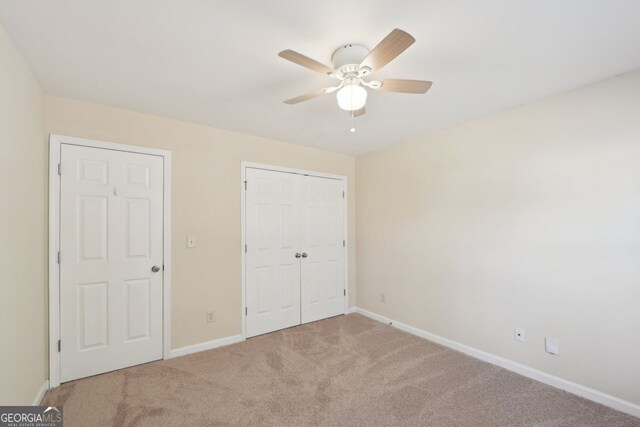 unfurnished bedroom with carpet flooring and ceiling fan