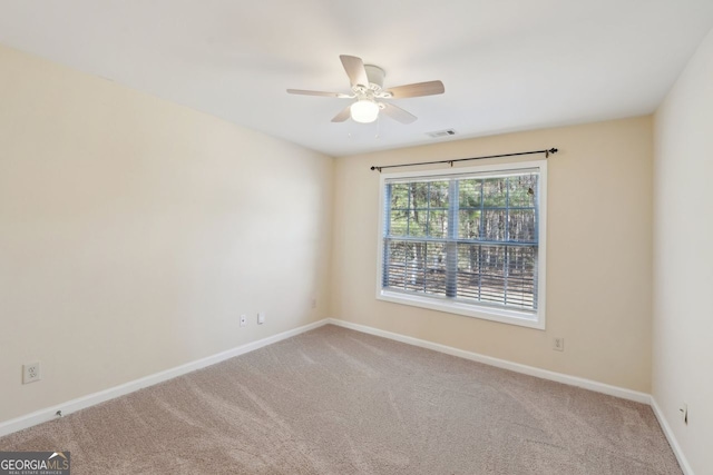 carpeted empty room with ceiling fan