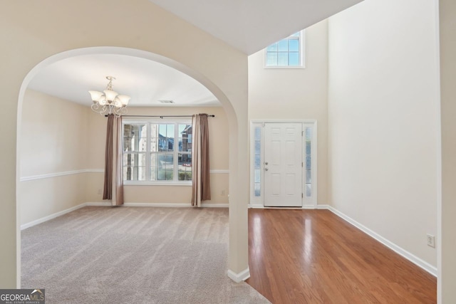 entrance foyer featuring lofted ceiling and a notable chandelier