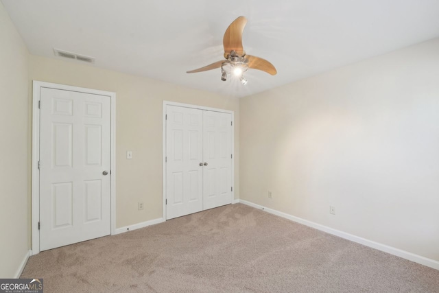 unfurnished bedroom featuring ceiling fan, carpet floors, and a closet