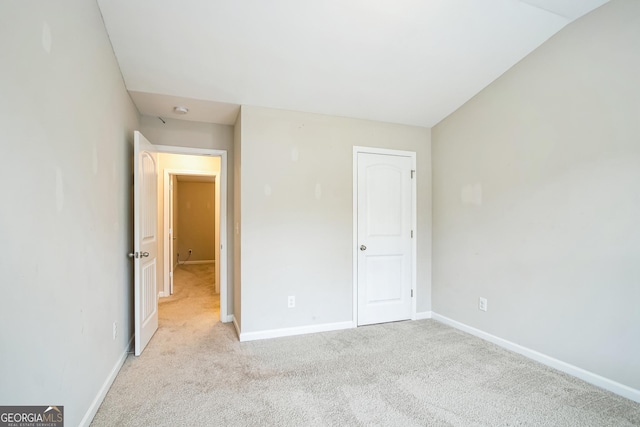 unfurnished bedroom featuring light colored carpet