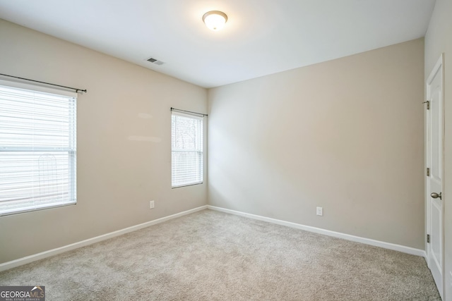 unfurnished room with light colored carpet