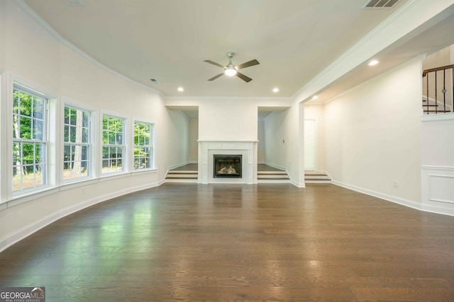 unfurnished living room with ceiling fan, crown molding, and dark wood-type flooring