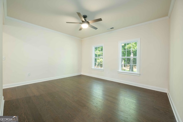 empty room with crown molding, dark hardwood / wood-style flooring, and ceiling fan