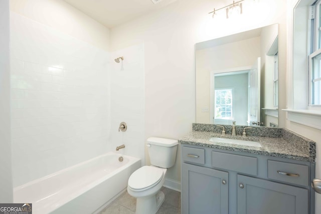 full bathroom with tile patterned flooring, vanity, tiled shower / bath combo, and toilet