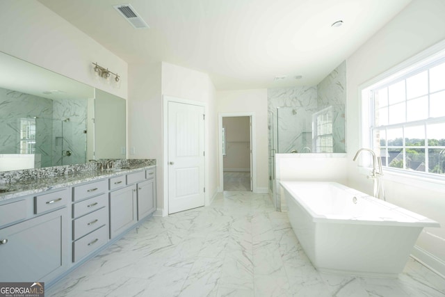 bathroom with vanity and independent shower and bath