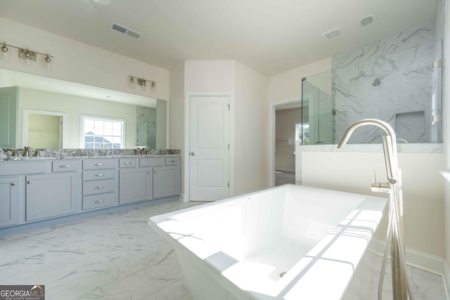 bathroom featuring vanity and a tub to relax in