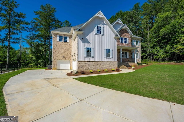 view of front of home featuring covered porch, a garage, and a front lawn