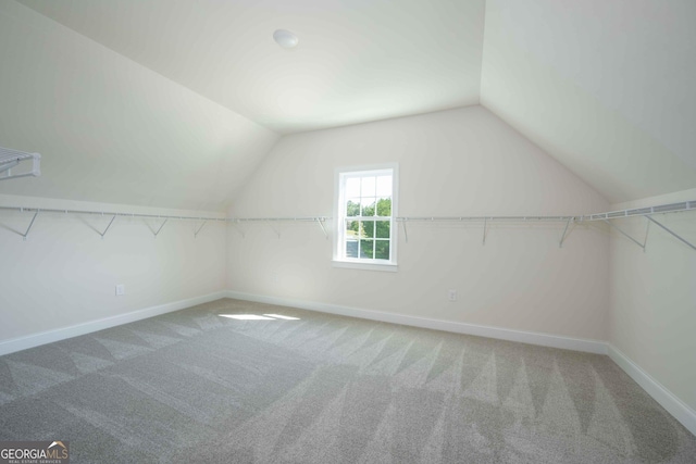 bonus room with carpet floors and vaulted ceiling