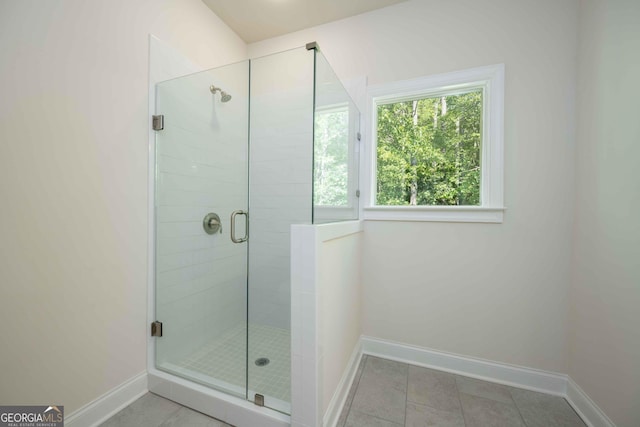 bathroom featuring tile patterned floors and a shower with shower door