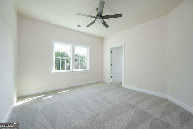 carpeted spare room with ceiling fan