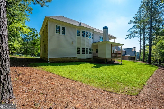 back of property featuring a lawn