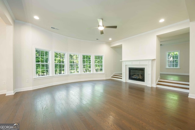 unfurnished living room with dark hardwood / wood-style flooring, ceiling fan, and ornamental molding