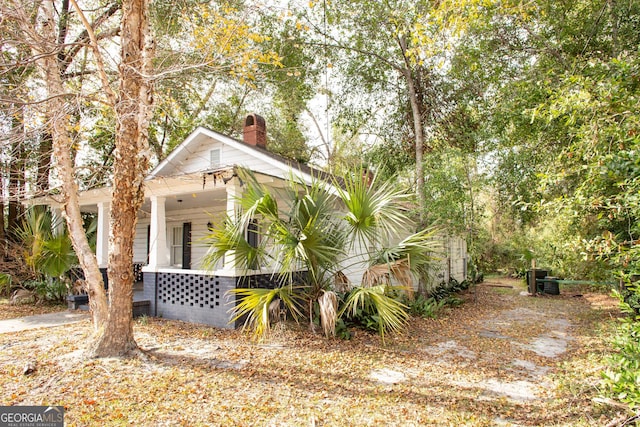 view of side of property with a porch