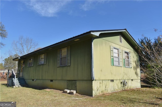 view of side of home featuring a lawn