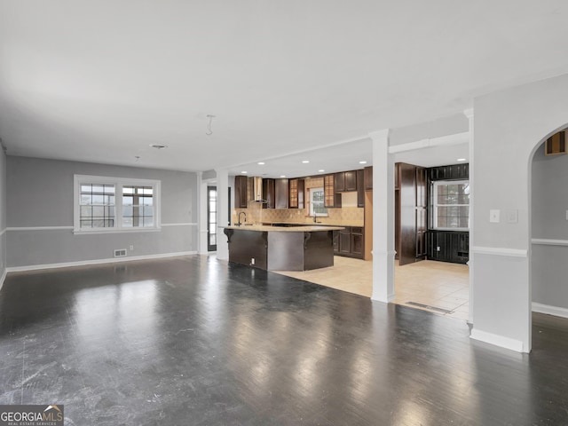 unfurnished living room featuring light hardwood / wood-style flooring and sink