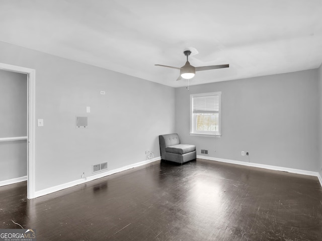 unfurnished room with ceiling fan and dark hardwood / wood-style flooring