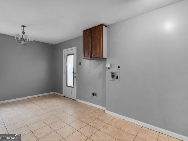 clothes washing area with cabinets, hookup for an electric dryer, a notable chandelier, hookup for a washing machine, and light tile patterned floors