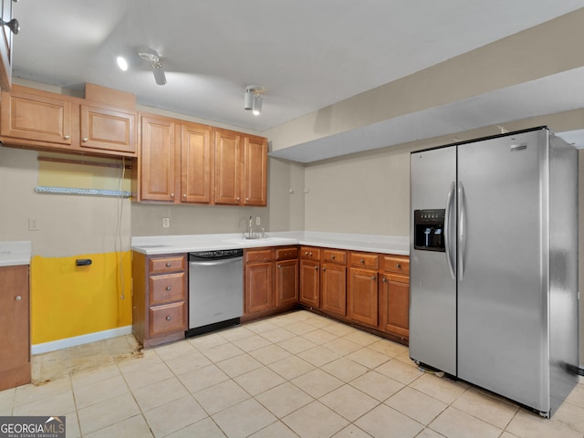 kitchen featuring sink, stainless steel appliances, and light tile patterned flooring