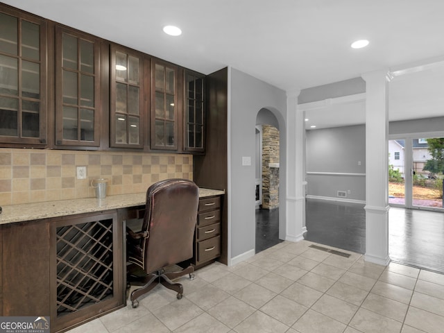 office with ornate columns, light tile patterned flooring, and beverage cooler