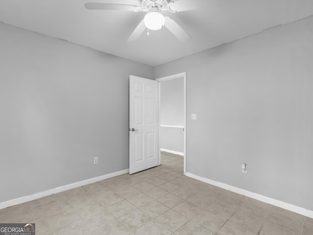 unfurnished room featuring ceiling fan and light tile patterned flooring