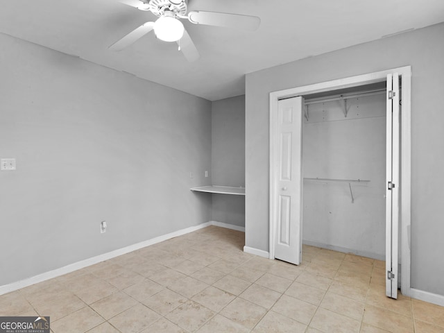 unfurnished bedroom with ceiling fan, light tile patterned floors, and a closet