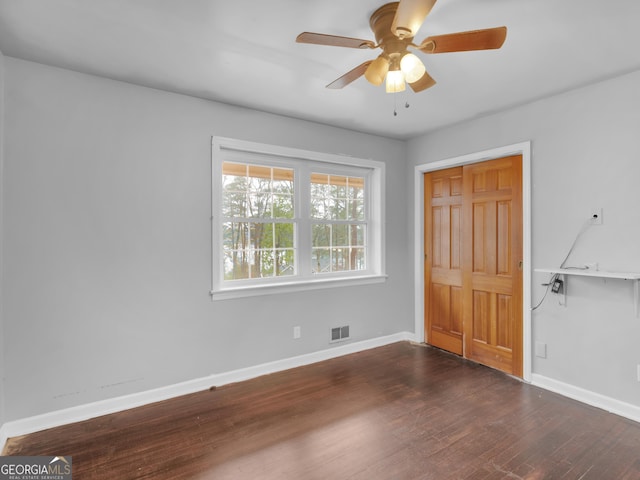 interior space featuring ceiling fan and dark wood-type flooring