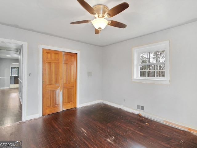 unfurnished bedroom featuring hardwood / wood-style floors, a closet, and ceiling fan