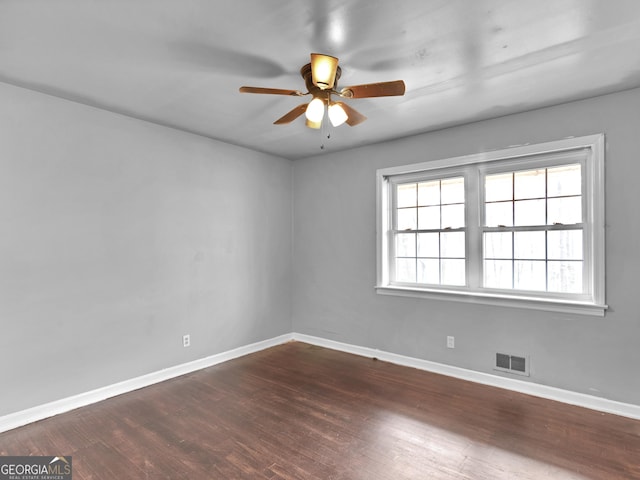 spare room with ceiling fan and dark wood-type flooring