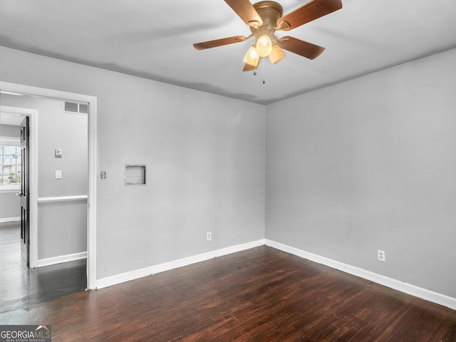 spare room featuring dark hardwood / wood-style floors and ceiling fan