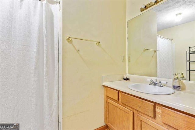 bathroom featuring vanity and a textured ceiling