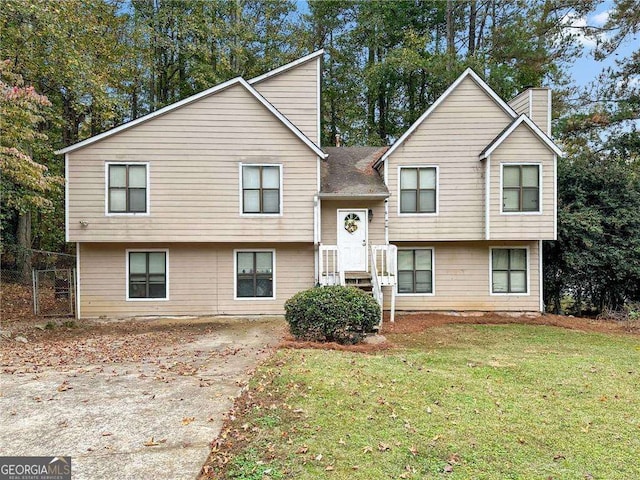 raised ranch featuring a front lawn