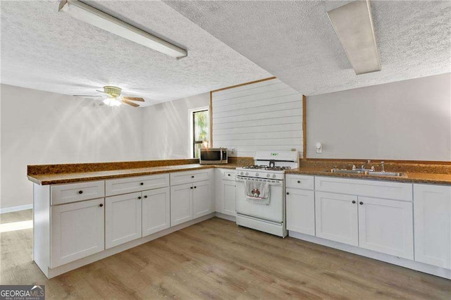 kitchen with white cabinetry and gas range gas stove