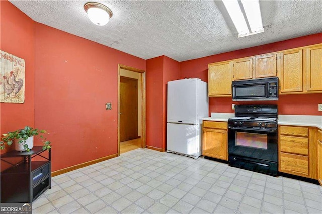 kitchen featuring black appliances and a textured ceiling