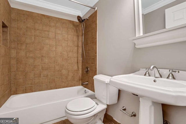 bathroom with crown molding, tiled shower / bath combo, and toilet