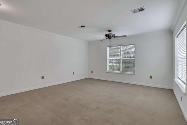 spare room featuring plenty of natural light and light colored carpet