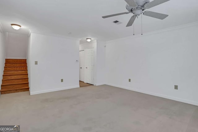 spare room with crown molding, carpet floors, and ceiling fan