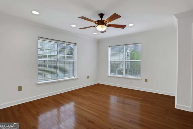 empty room with ceiling fan and dark wood-type flooring