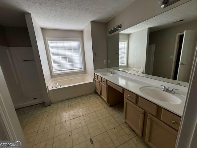 bathroom featuring vanity, a textured ceiling, and shower with separate bathtub