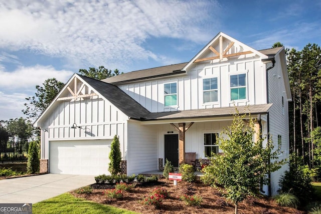 view of front of property with covered porch and a garage