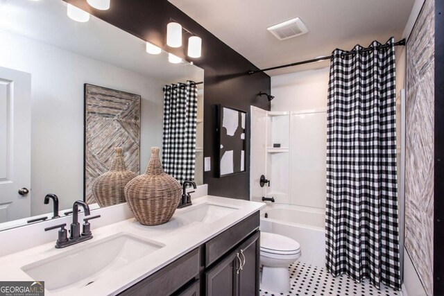 full bathroom featuring tile patterned flooring, shower / tub combo with curtain, vanity, and toilet