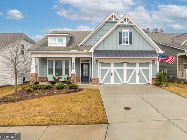 craftsman inspired home with a front yard and a garage